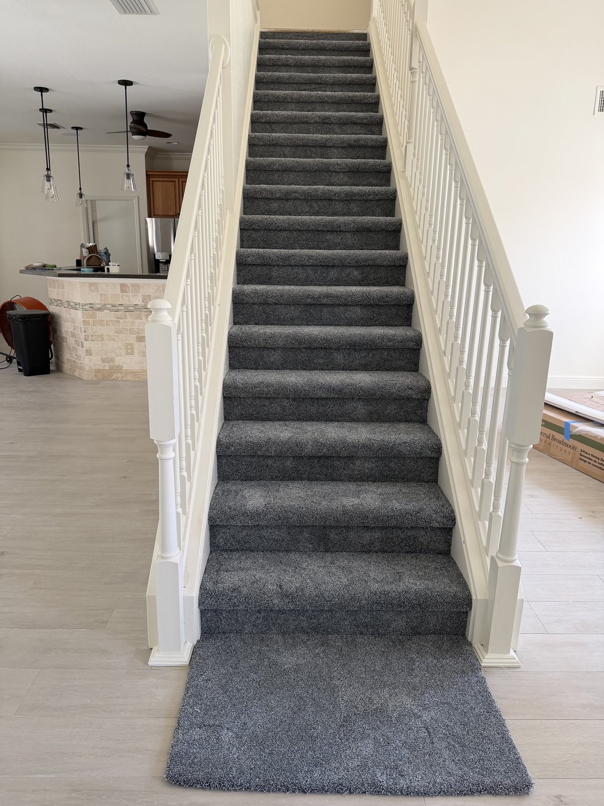 Full staircase in charcoal carpet with white balustrade