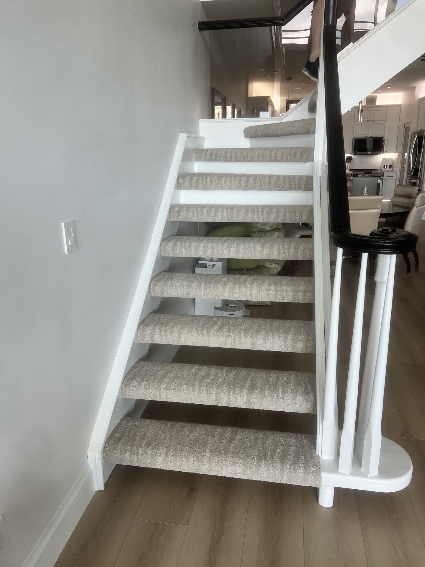 Carpet stair runner fitted to a wooden staircase